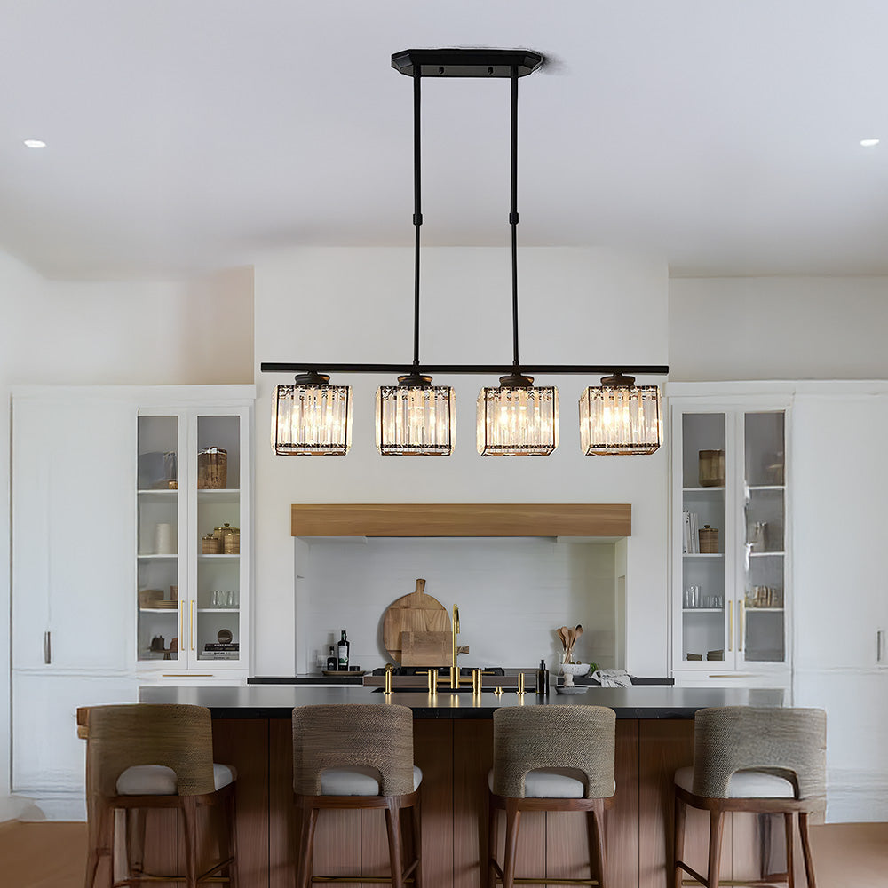 Black kitchen island pendant light above a breakfast bar with four rattan stools