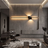 Black LED wall sconce on concrete wall in a modern lounge