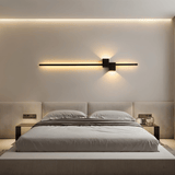 Black minimalist LED wall sconce packaged with mounting hardware
