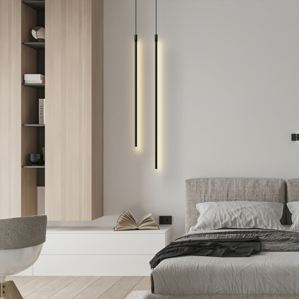 Pair of black linear pendant lights in a bedroom setting