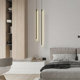 Pair of black linear pendant lights in a bedroom setting