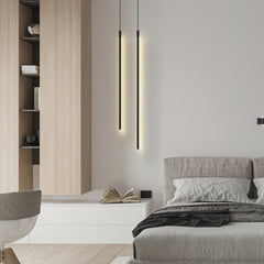 Pair of black linear pendant lights in a bedroom setting