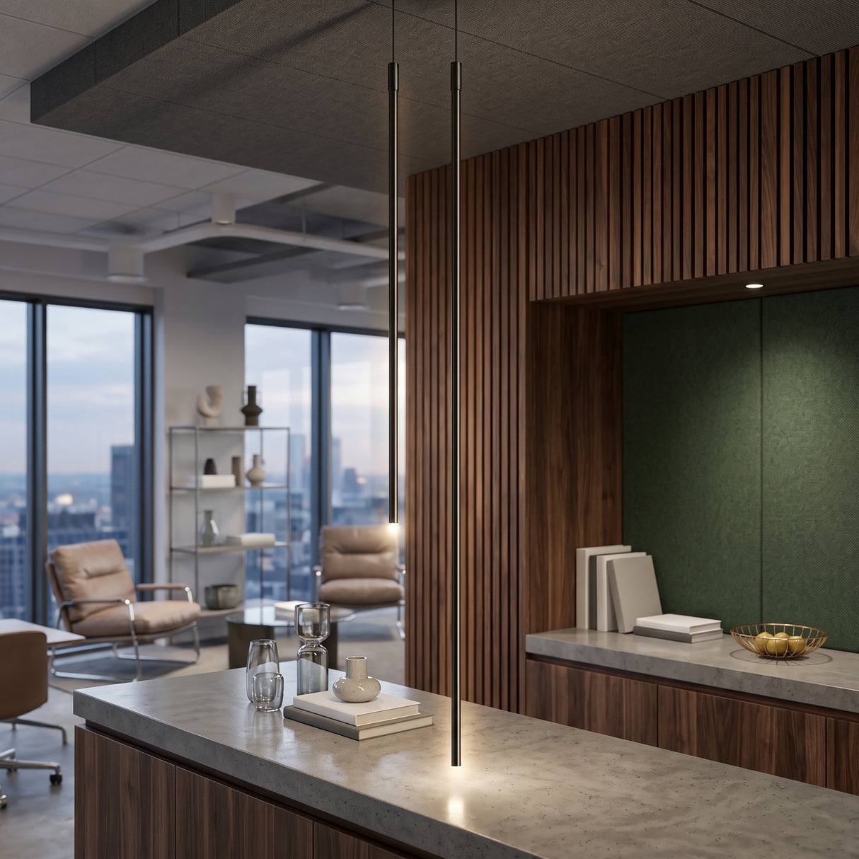 Two black linear tube pendant lights hanging over a stone kitchen island