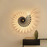 Gold shell design wall light on a studio background