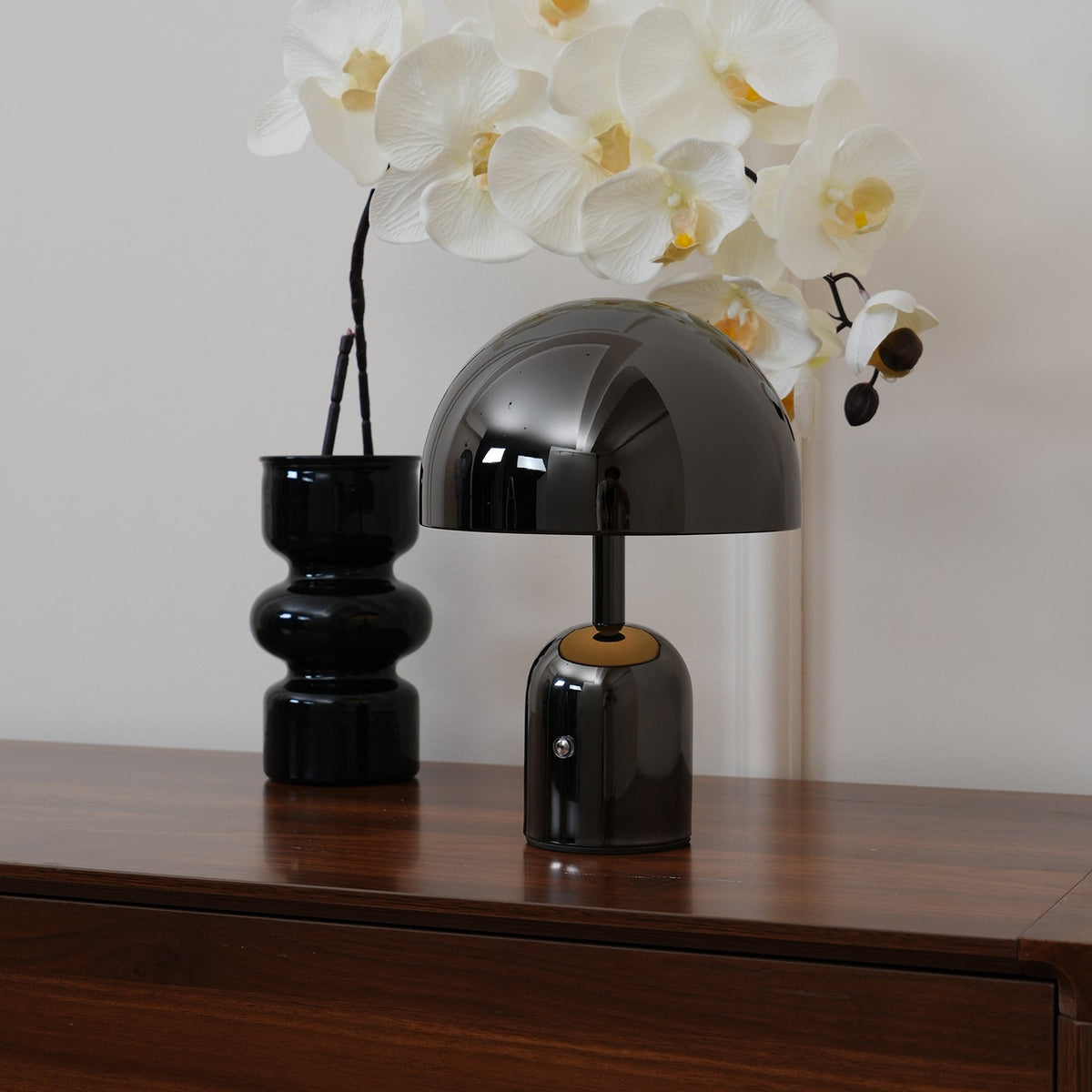 Detail of the black lamp base and stem where the shade meets the column