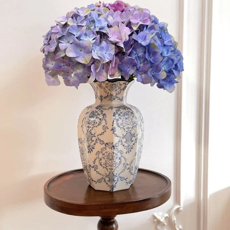 Blue and white ceramic flower vase styled on modern console
