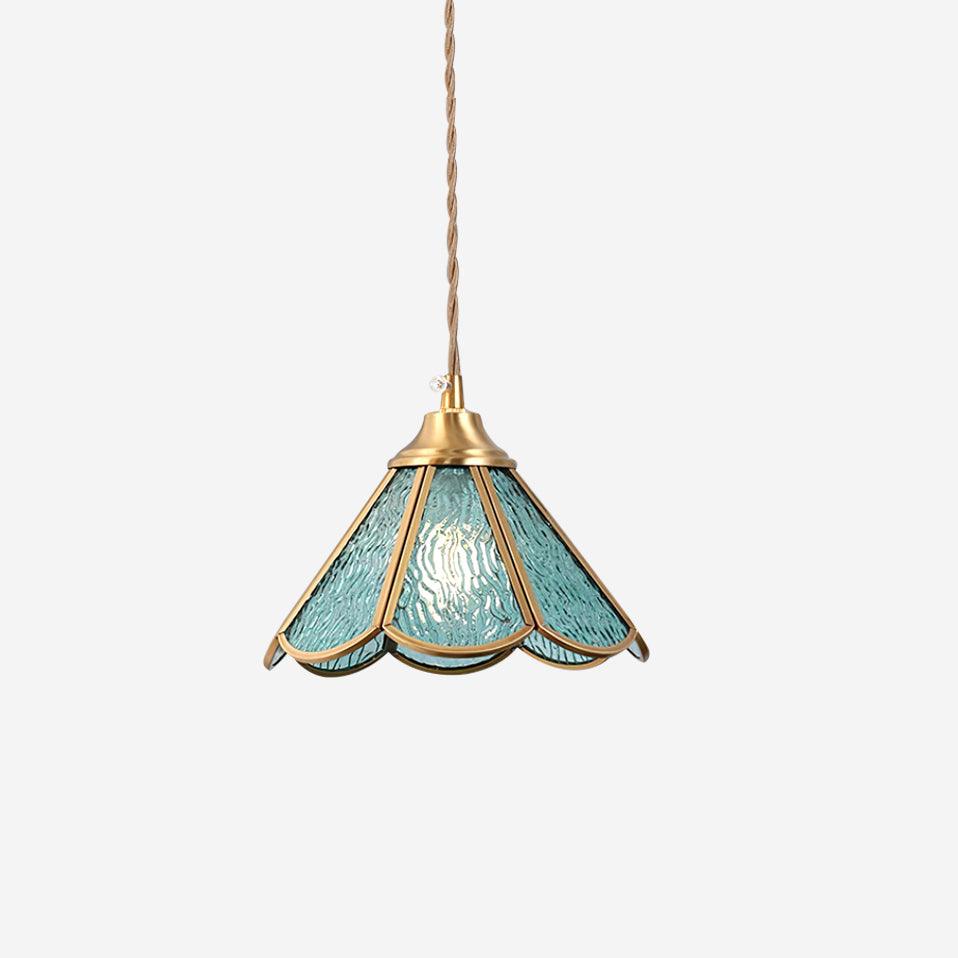 Studio view of the blue panelled glass shade in its scalloped brass frame