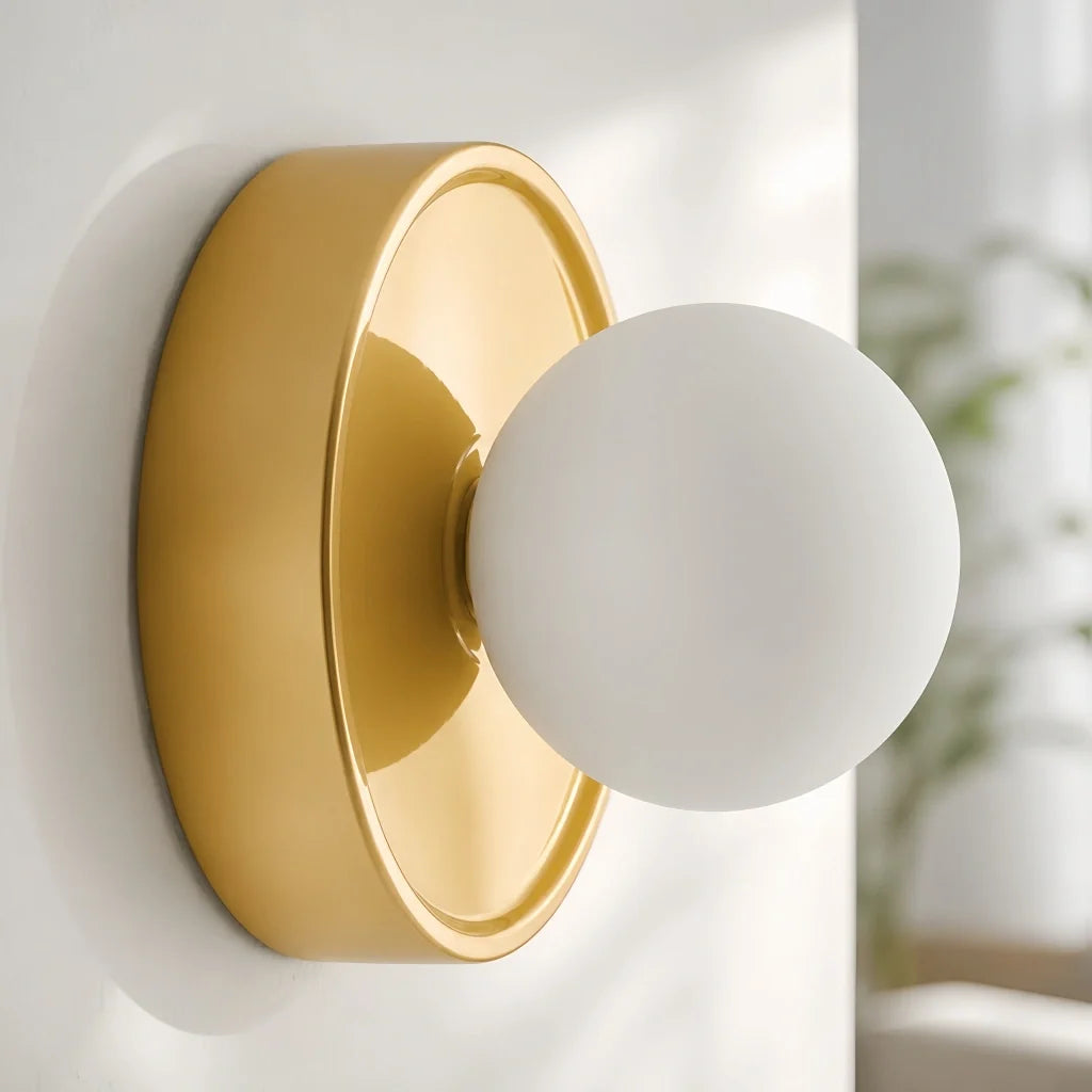 Blue orb wall sconce detail with the frosted globe unlit and centred