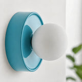 Blue orb wall sconce rear view showing the round mounting plate