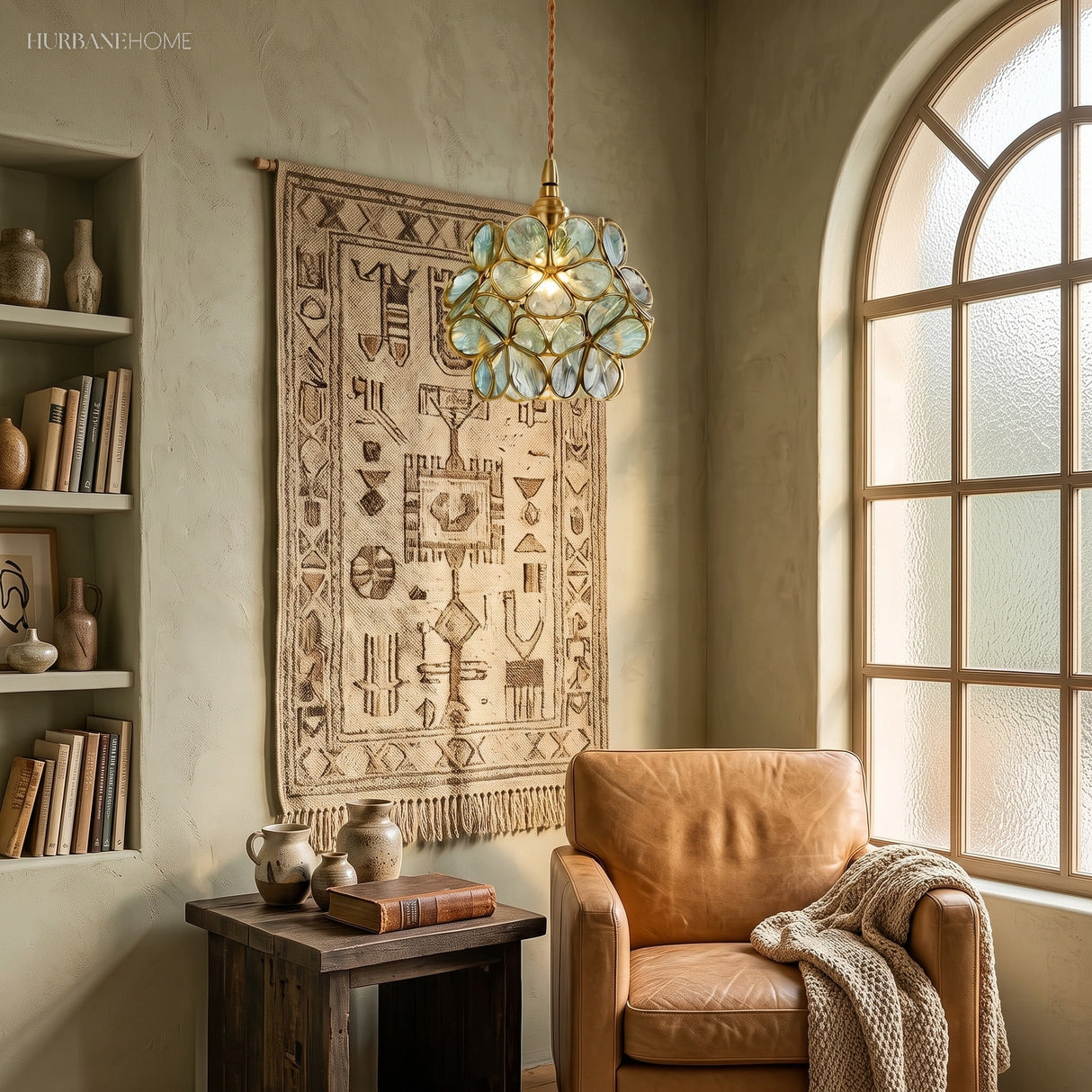 Blue petal glass pendant light hanging in a cosy reading nook by a window
