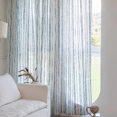Blue white curtains striped hanging in bright living room