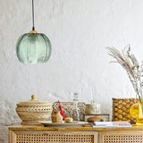 Boho green leaf glass pendant styled against a natural nature inspired backdrop