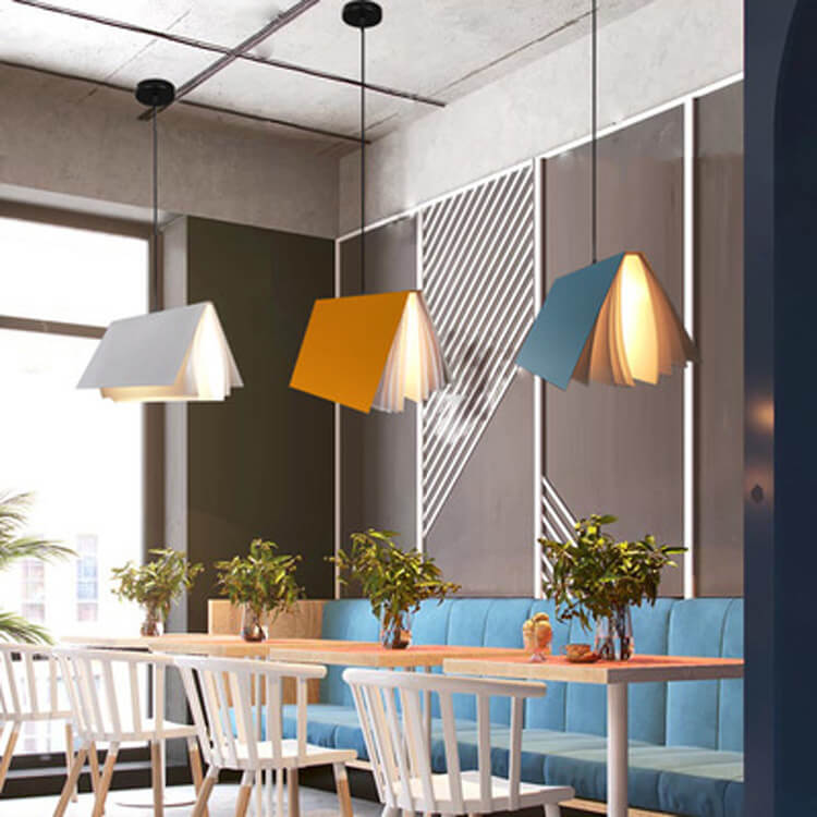 Yellow blue and white book pendant lights in a modern cafe