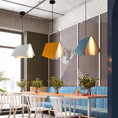 Yellow blue and white book pendant lights in a modern cafe