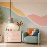 Pink and light green pendant above a living room with sage armchair and mural