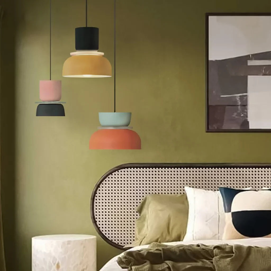 Four colorful pendant lights in an olive-green bedroom