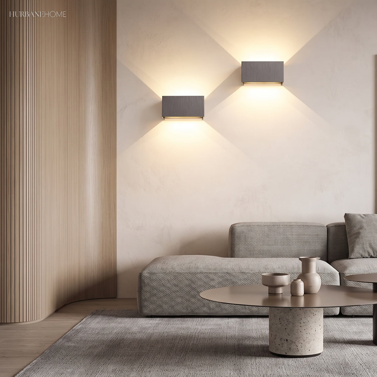 White wall sconce accenting a living room wall with warm glow