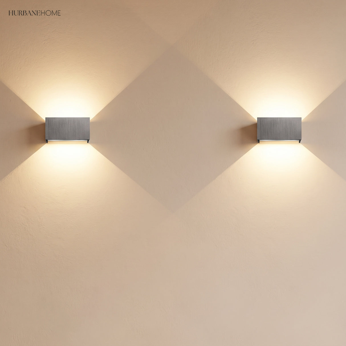Pair of aluminum up down sconces mounted along a bright wall