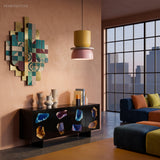 Yellow and pink bowl pendant light over a dining table with abstract wall art