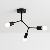 Black three light branch fixture mounted on a white ceiling