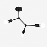 Black three light branch fixture shown against a plain backdrop