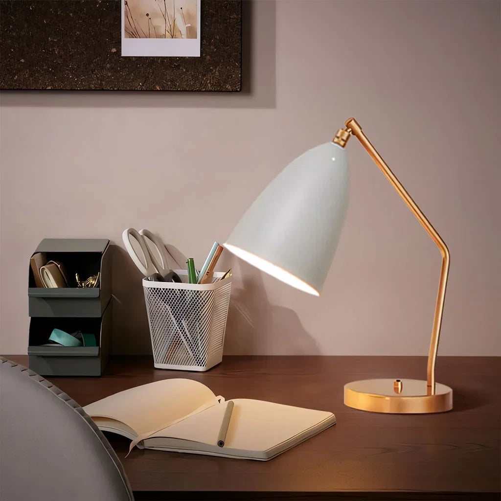 Brass adjustable task table lamp on a desk