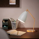 Brass adjustable task table lamp on a desk
