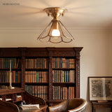 Flared glass panel ceiling light lit above a library reading chair