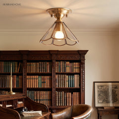 Flared glass panel ceiling light lit above a library reading chair
