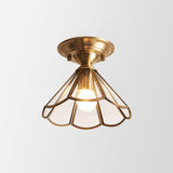 Flared glass panel shade in a brass frame shown on plain white