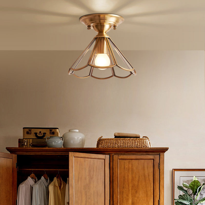 Flared glass panel ceiling light lit above a timber wardrobe