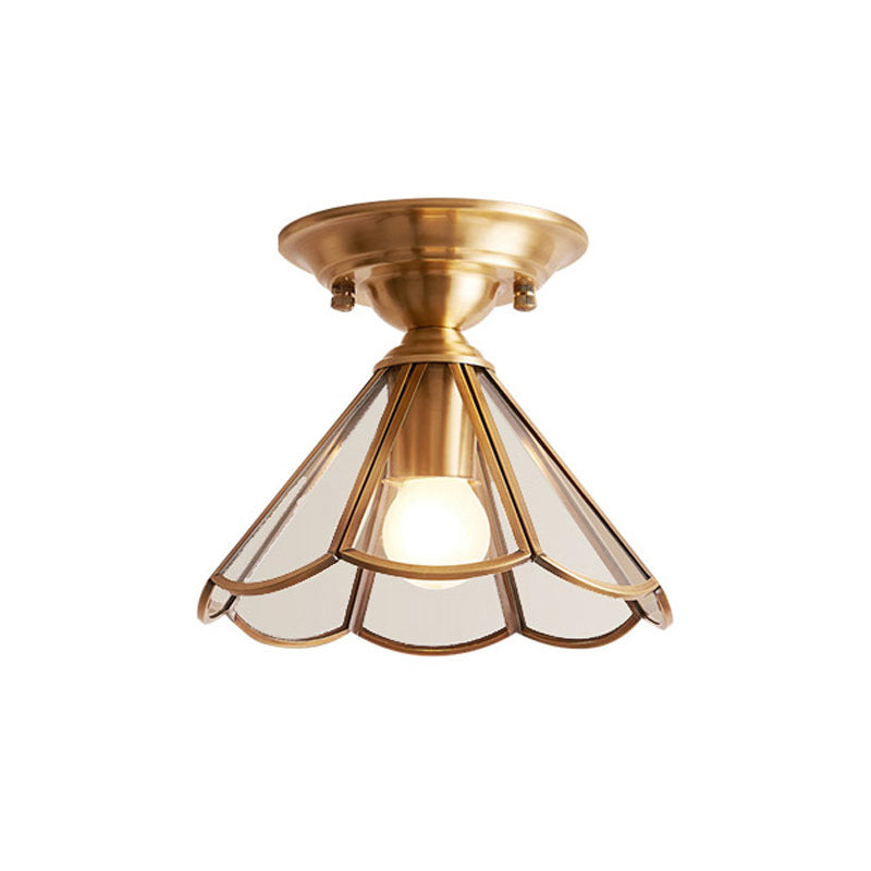 Wide scalloped glass panel ceiling light lit on a plain background