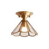 Wide scalloped glass panel ceiling light lit on a plain background
