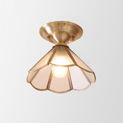 Wide scalloped glass panel shade in a brass frame on plain white