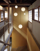 Brass stem globe pendant light with a black rod finish, view 8