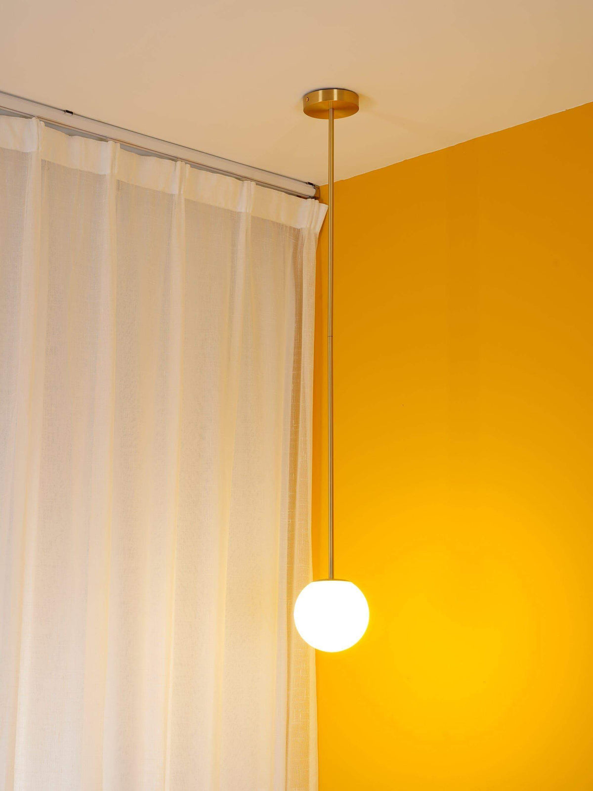 Brass rod pendant light with a 3.6 inch opal glass globe, view 11