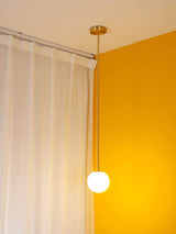 Brass rod pendant light with a 3.6 inch opal glass globe, view 11
