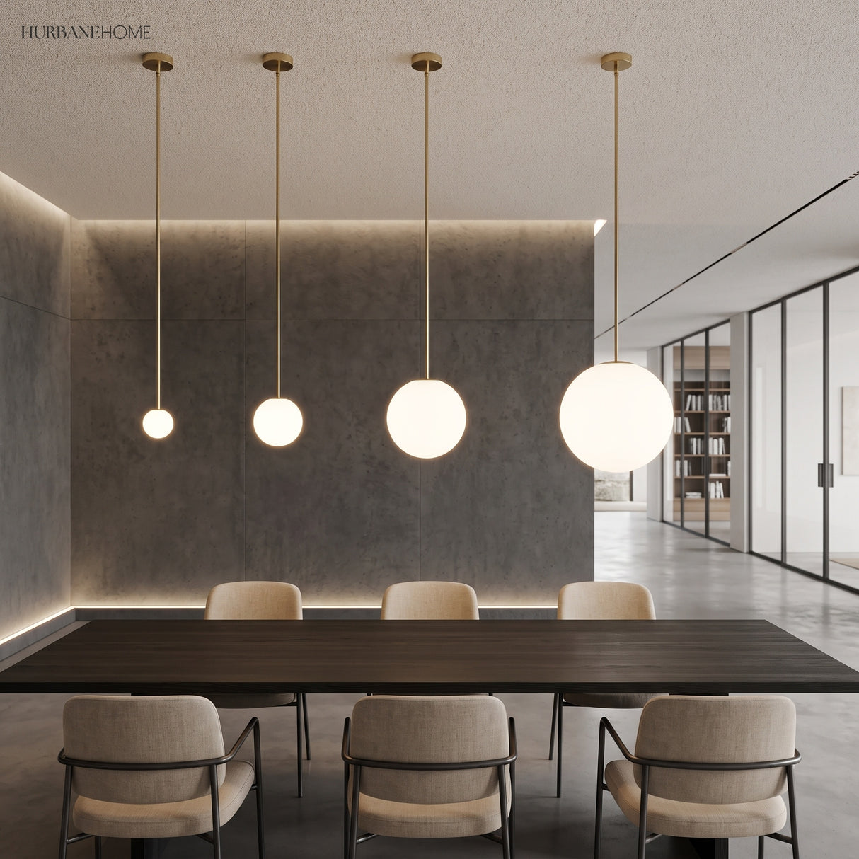 Four brass stem globe pendants in graduated sizes above a dining table