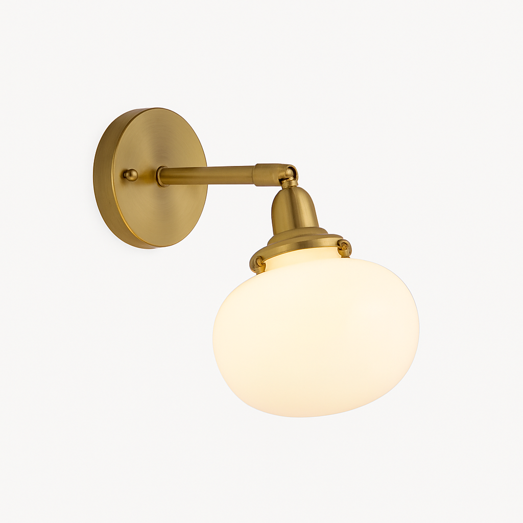 Brass wall sconce holding a smooth white opal glass shade