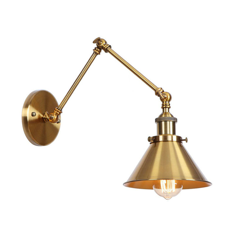 Brass sconce with a cone shade lit warm on a white background