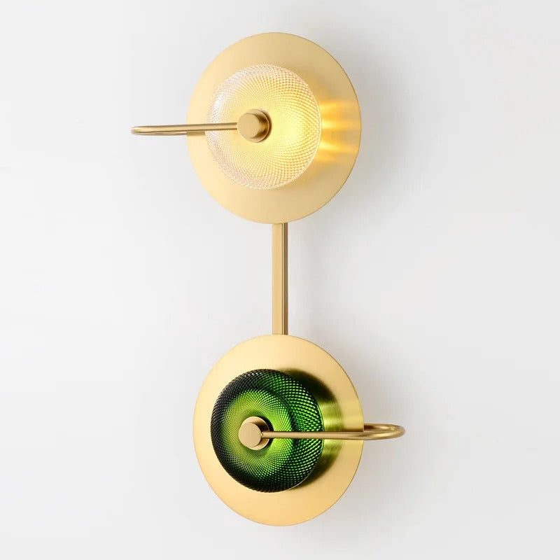 Two light brass sconce with green glass discs stacked on one backplate