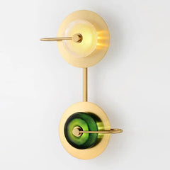 Two light brass sconce with green glass discs stacked on one backplate