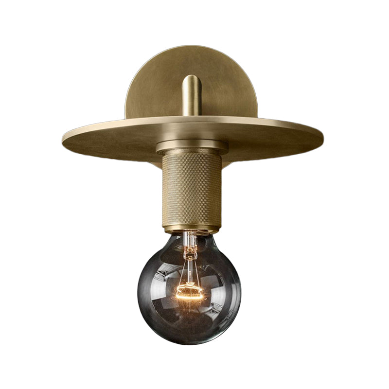 Flat metal disc shade sconce photographed on a white background