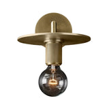 Flat metal disc shade sconce photographed on a white background