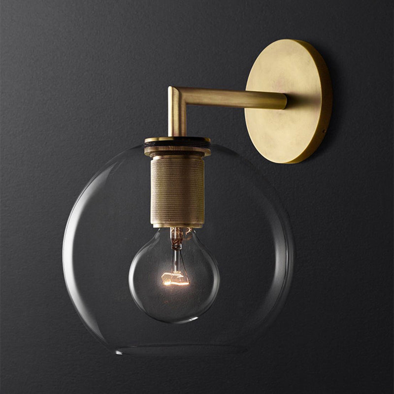 Angled view of the globe sconce showing the arm and backplate