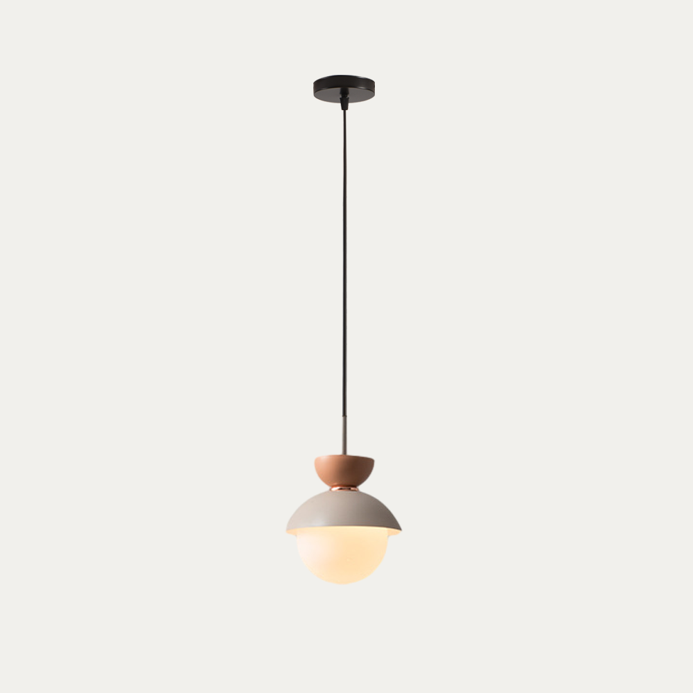 Grey macaron pendant light glowing warmly in a quiet corner