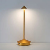 Gold cordless table lamp close up showing the polycarbonate shade