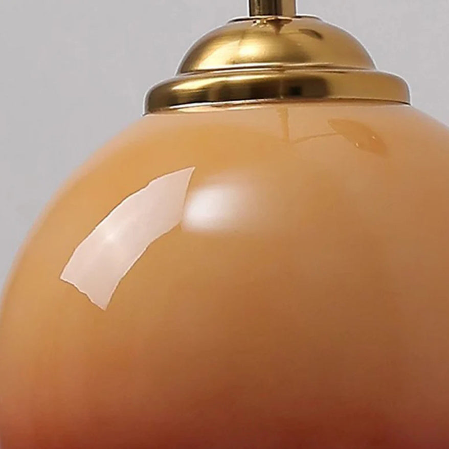 Caramel dome glass sconce angled view on round ash wood plate