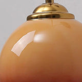 Caramel dome glass sconce angled view on round ash wood plate