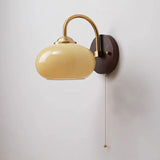 Caramel oval sconce fading to red at the base on wood plate